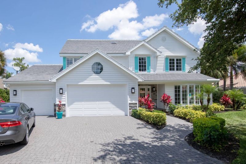 White home with new grey tile roof