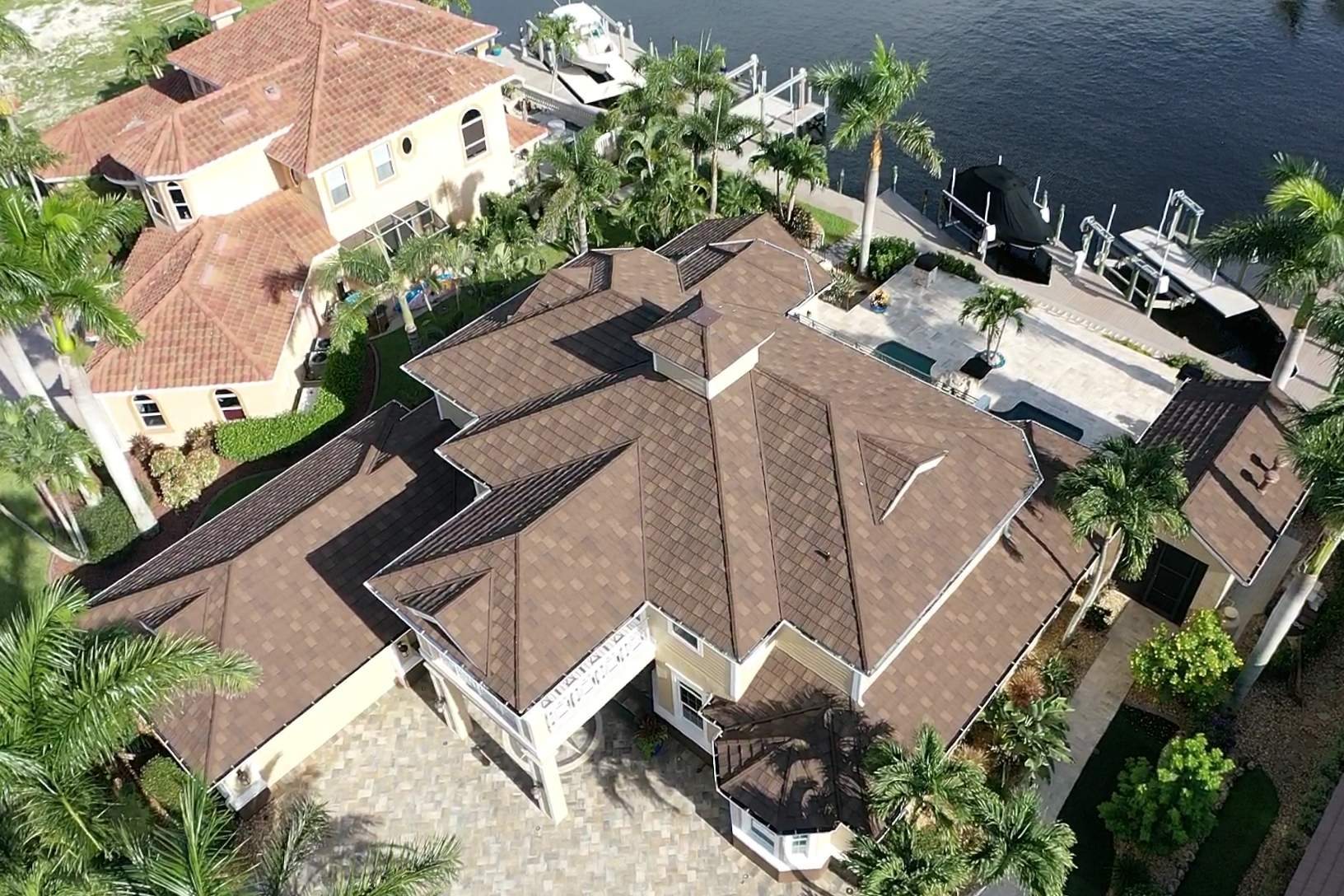 Black DECRA stone-coated metal roof on a waterfront home